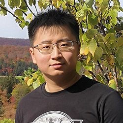 Image of Franklin Mingzhe Li, an asian man with black hair, wearing a black t-shirt, with a background of tree leaves.