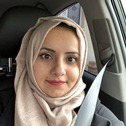 Maryam, a South Asian woman wearing a beige headscarf